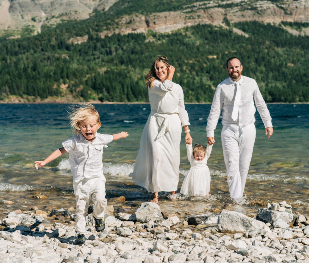 A family plays in the lake at Glacier National Park
