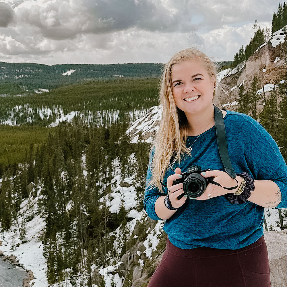 Photographer Kat Simecek poses in Yellowstone National Park in Winter